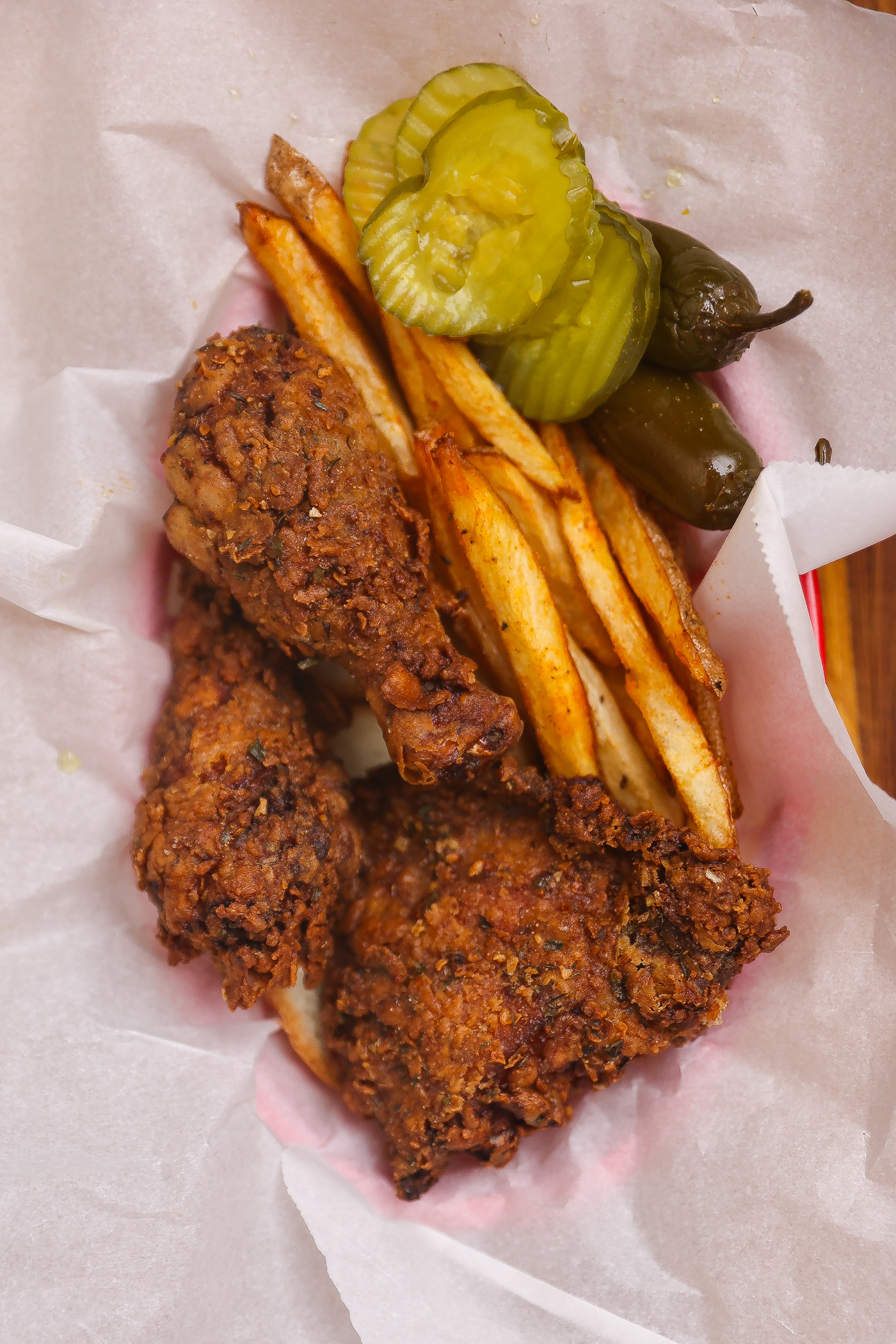 fried chicken pieces and fries in a basket