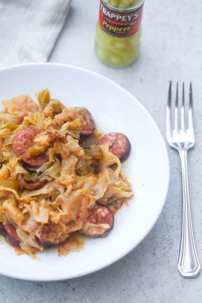 cabbage and sausage on a white plate