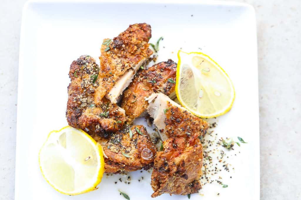 lemon pepper fried chicken on white plate