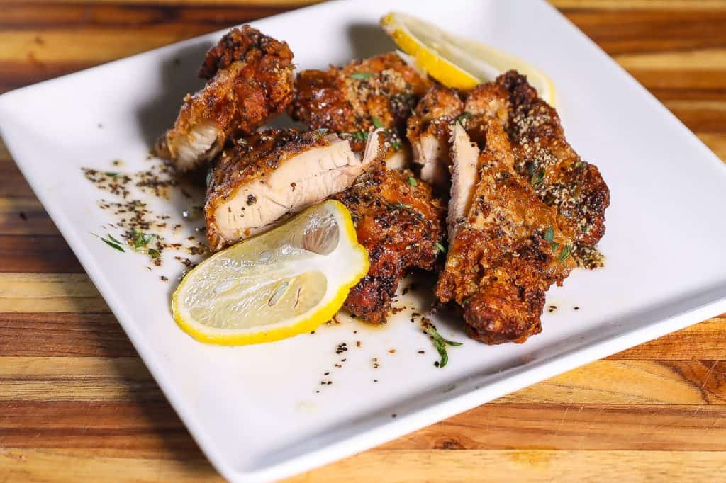 lemon pepper fried chicken on white plate