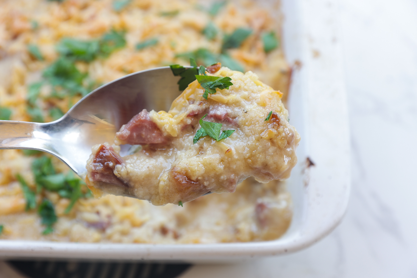 baked grits with cheese in white pan