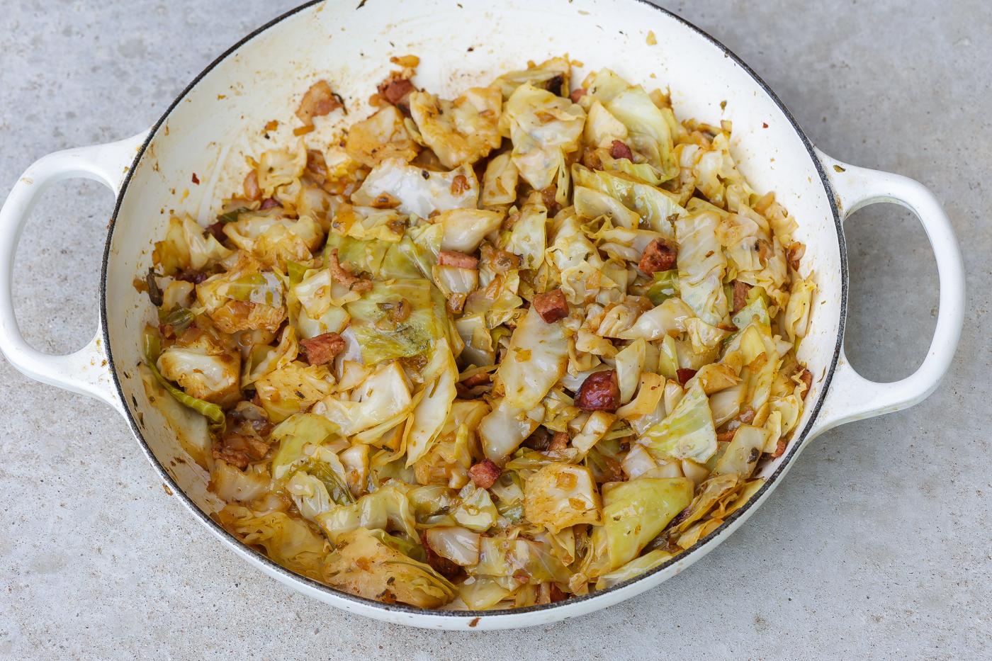 smothered cabbage in white pan