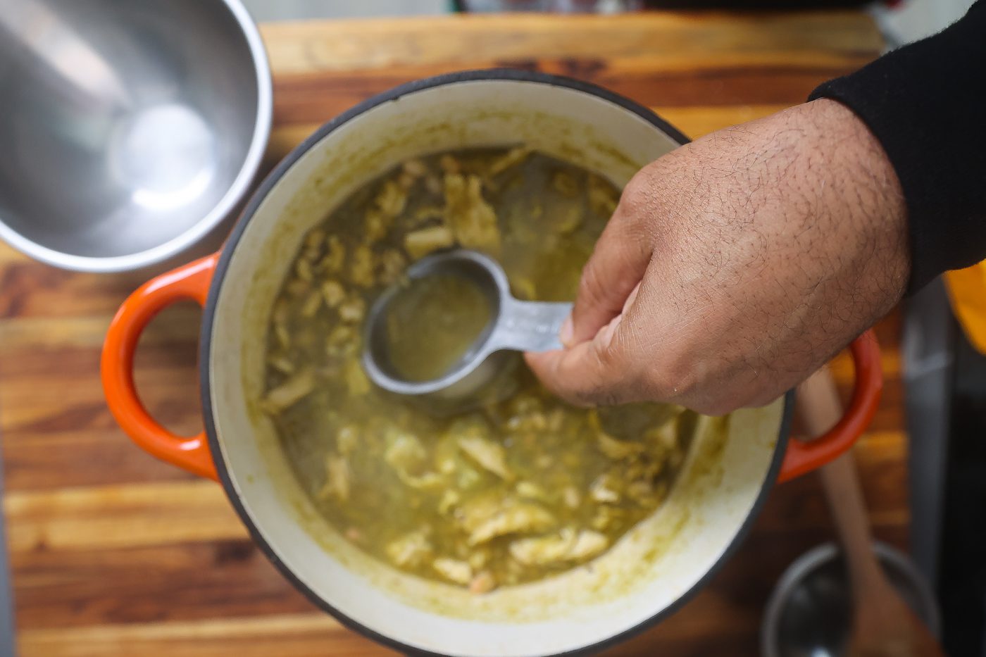 green chicken chili in orange pot