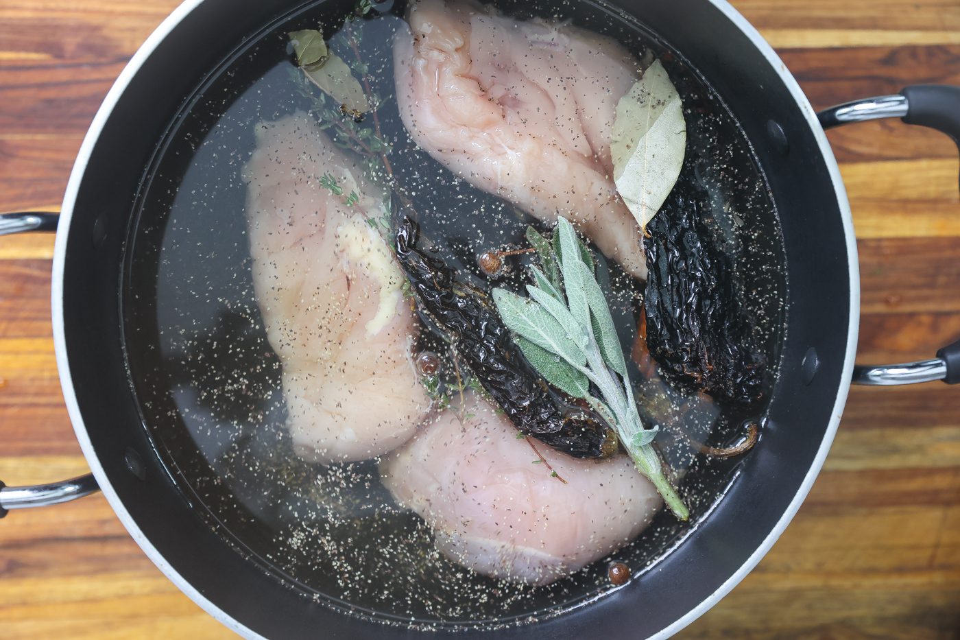 vegetables and chicken breast cooking in pot