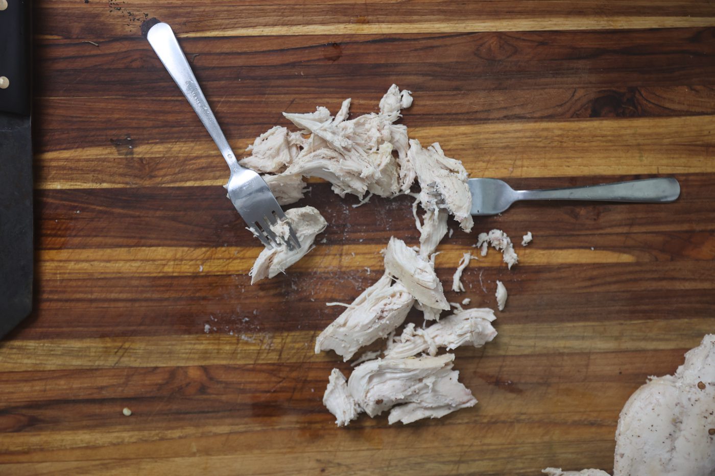 shredded chicken on cutting board