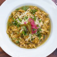 green chicken chili in a white bowl