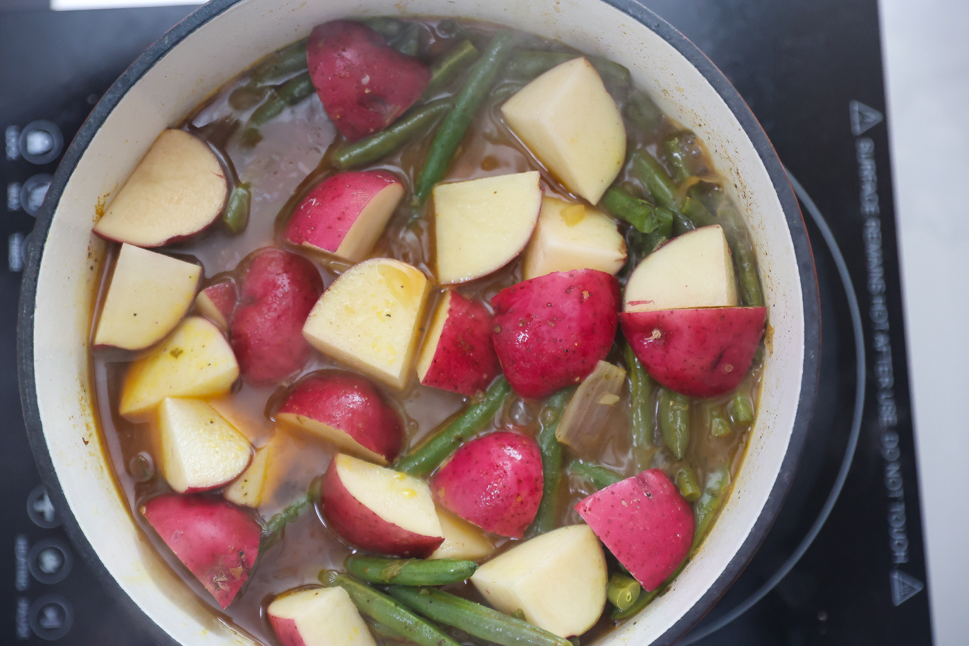 green beans and potatoes cooking in pot