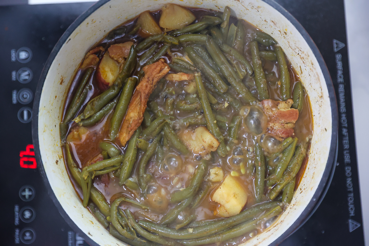 green beans and potatoes cooking in pot