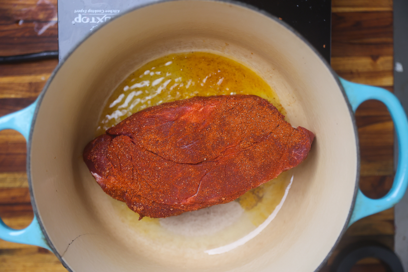 seasoned pot roast browning in pot