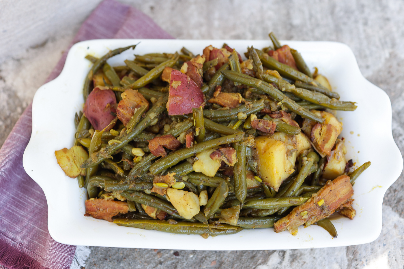 southern greens beans and potatoes in white pan