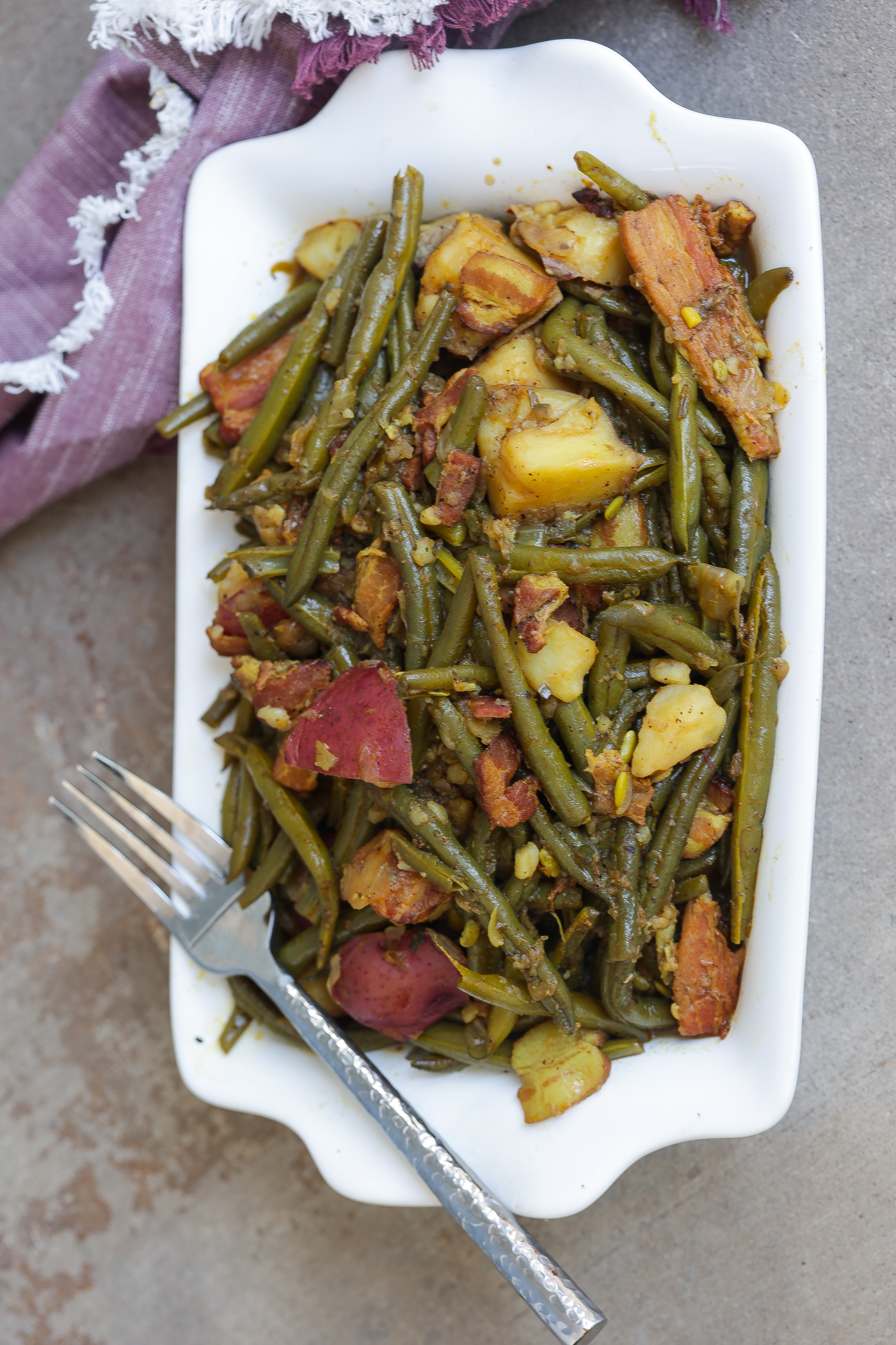 southern greens beans and potatoes in white pan