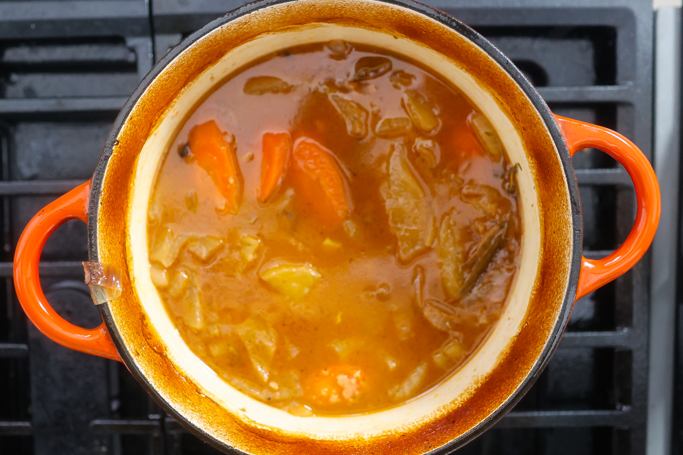 braising liquid cooking in a large pot