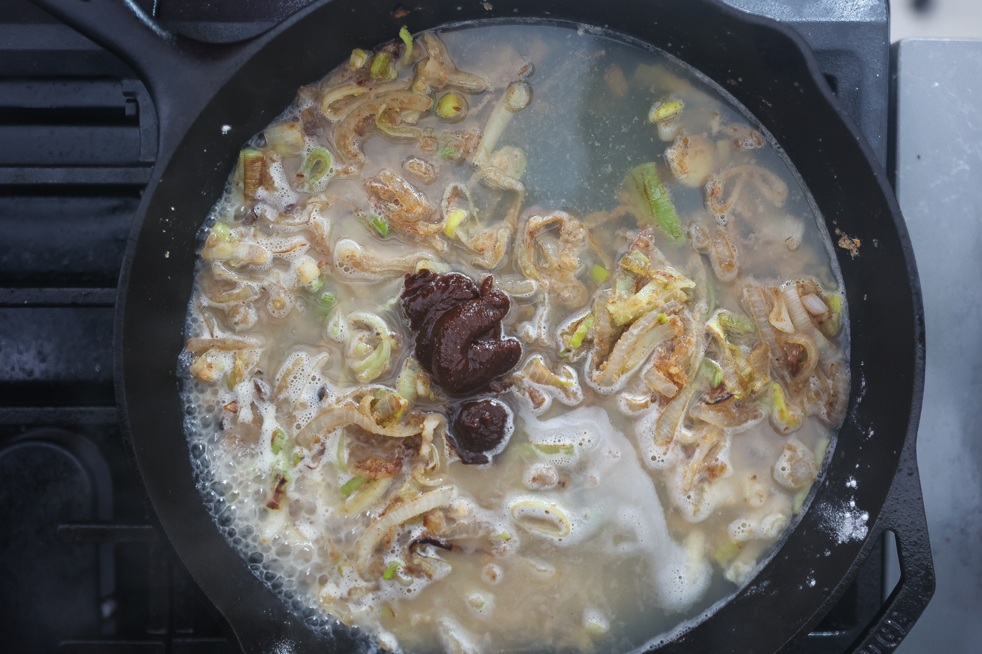 onions, miso, and leeks cooking in skillet